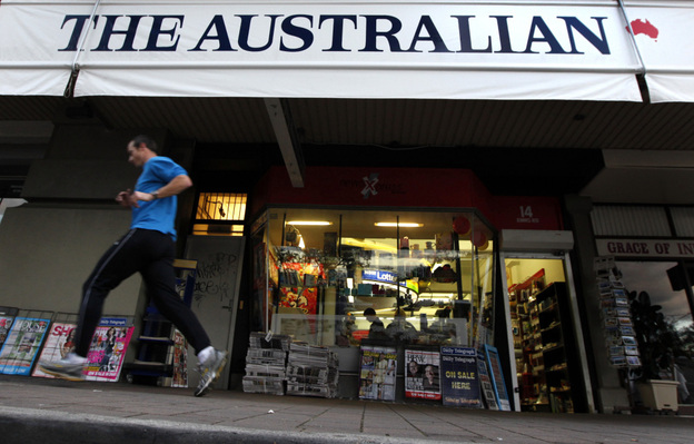 A jogger runs past a banner for The Australian, part of Rupert Murdoch's newspaper empire, in Sydney last year. 