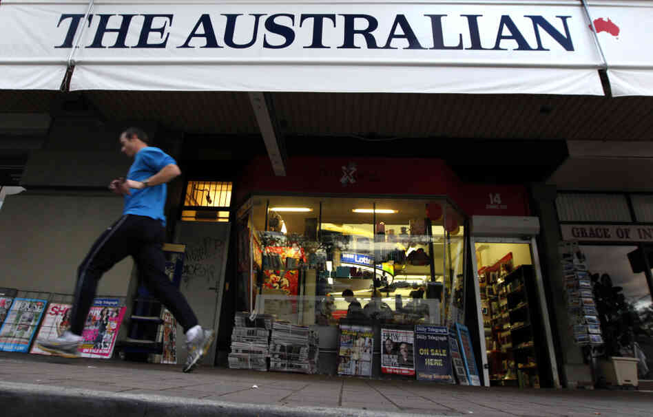 A jogger runs past a banner for The Australian, part of Rupert Murdoch's newspaper empire, in Sydney last year. 