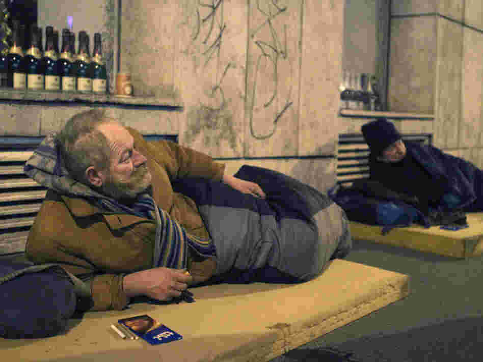 Two homeless men lie on mattresses in central Budapest in 2010. Hundreds of people live on the streets in the Hungarian capital; many refuse to stay in night shelters for fear of having their goods stolen.
