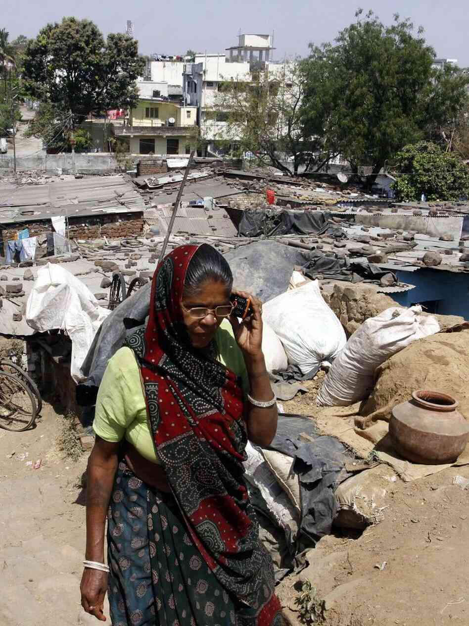 A woman talks on her cellphone in a slum area of Bhopal last month.