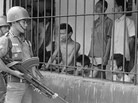 A coup attempt in Indonesia on Sept. 30, 1965, triggered a series of events that led to the ouster of President Sukarno and unleashed a wave of violence against suspected communists in the country that left up to 1 million people dead. In this photo from 1965, Indonesian soldiers watch suspected communists held at Tangerang, a suburb of Jakarta, the Indonesian capital. A coup attempt in Indonesia on Sept. 30, 1965, triggered a series of events that led to the ouster of President Sukarno and unleashed a wave of violence against suspected communists in the country that left up to 1 million people dead. In this photo from 1965, Indonesian soldiers watch suspected communists held at Tangerang, a suburb of Jakarta, the Indonesian capital.