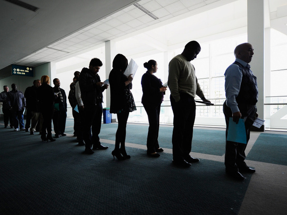 Job seekers line up to enter a career fair in Los Angeles. Both Congress and states are cutting back on unemployment benefits. 