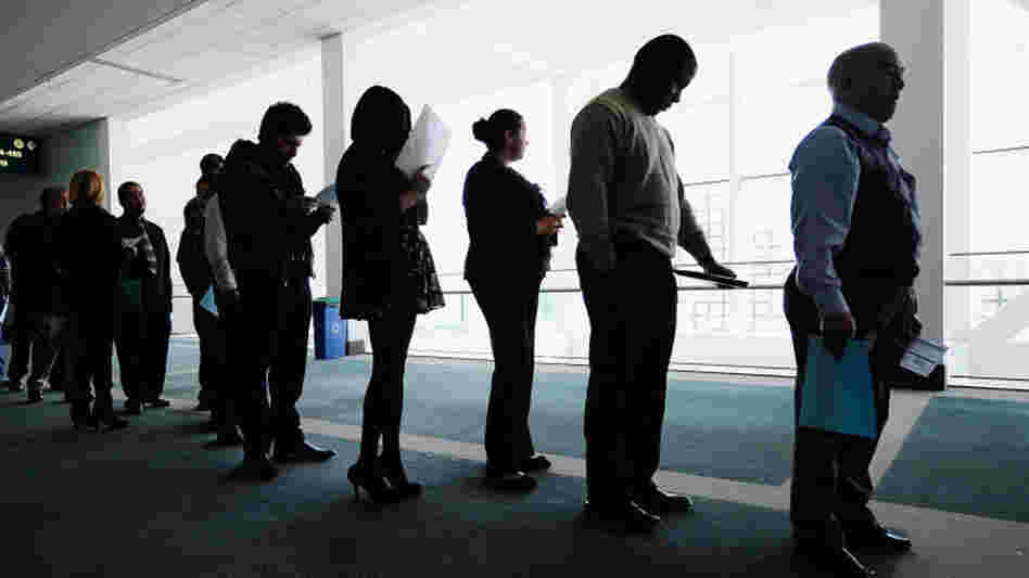 Job seekers line up to enter a career fair in Los Angeles. Both Congress and states are cutting back on unemployment benefits. 
