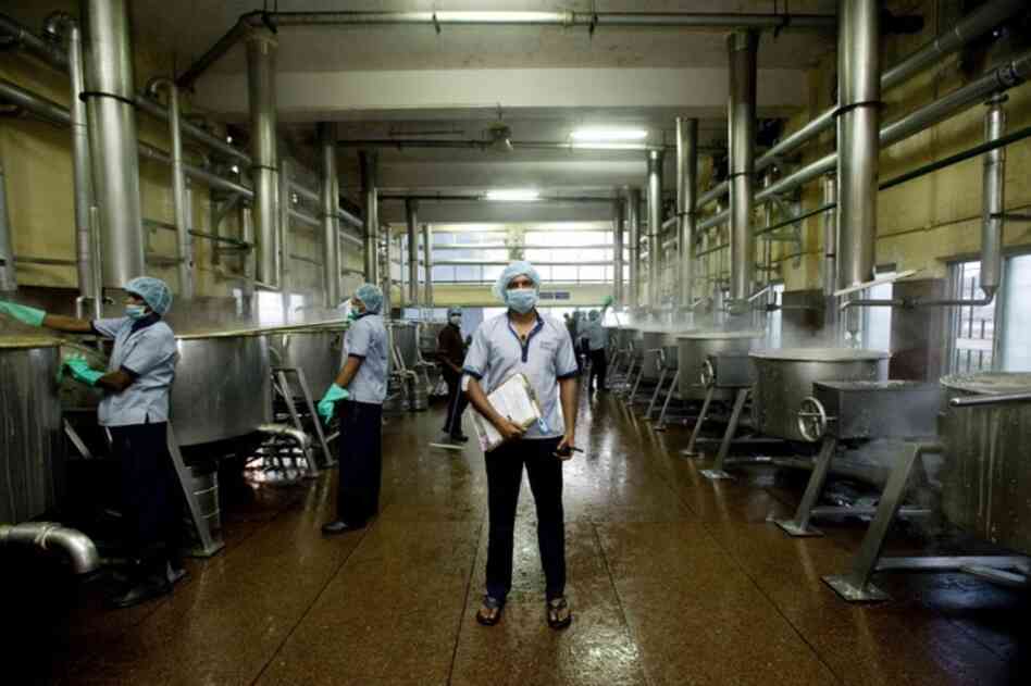 One of Akshaya Patra's kitchens, just outside Bangalore, churns out an average of 17,000 pounds of rice and 4,500 gallons of lentil soup every school day. A kitchen overseer checks in on the food preparation in the early morning.