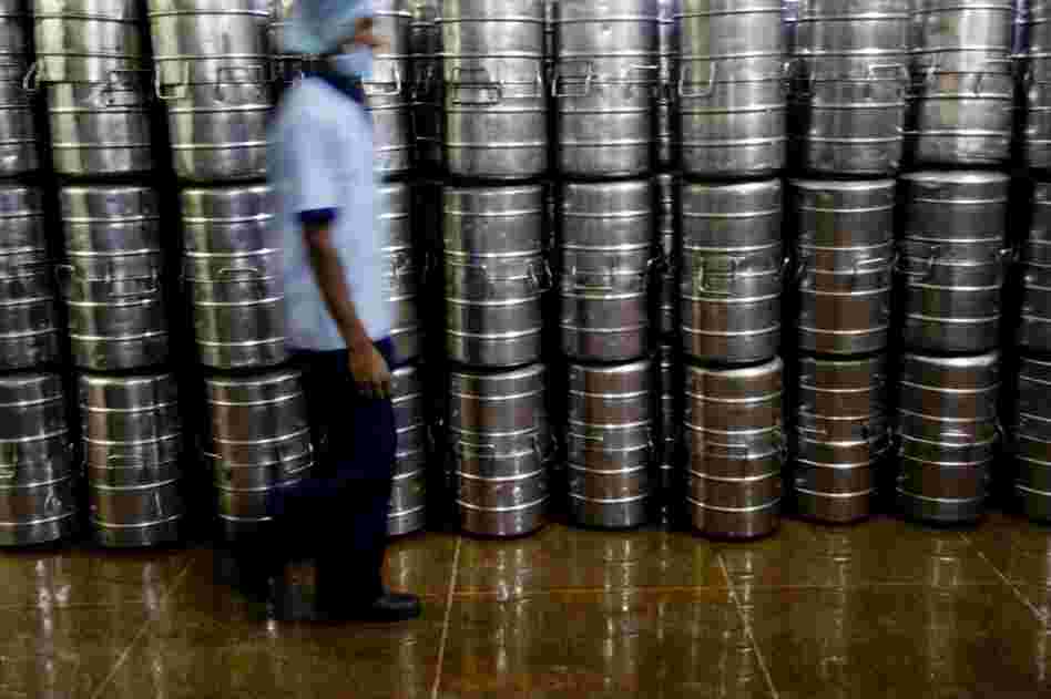 Freshly cooked food is packed in stainless steel containers before being transported to various schools in custom-built vehicles.
