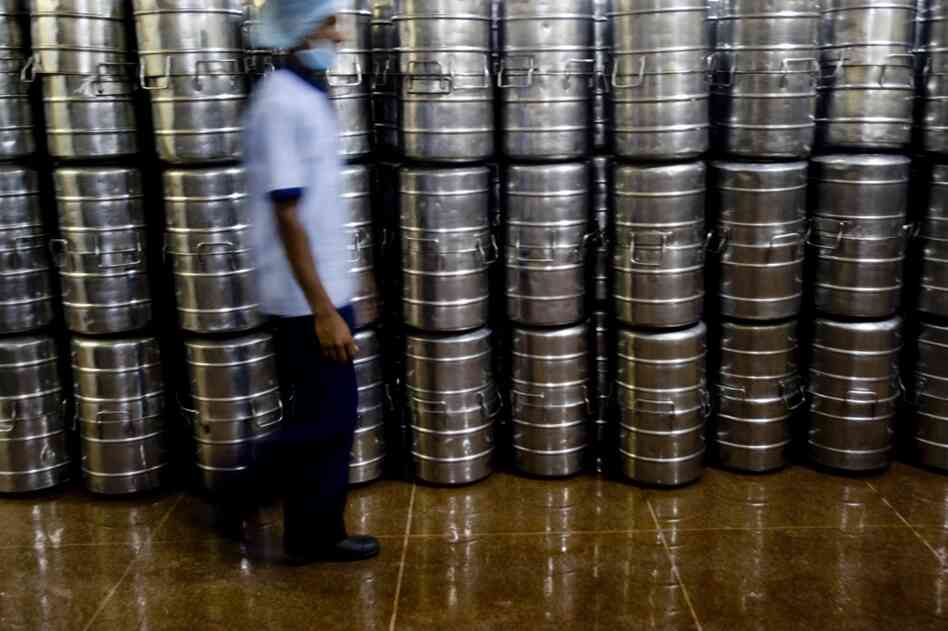 Freshly cooked food is packed in stainless steel containers before being transported to various schools in custom-built vehicles.