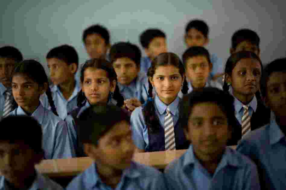 Many malnourished students have benefitted from the Akshaya Patra school lunch program. Bangalore middle school student K. Suchitra (center), 13, often comes to school with an empty stomach, but she knows she'll eat at school and can have as many servings as she wants.