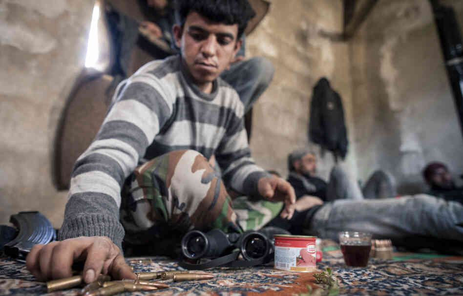 A Syrian soldier who defected and joined the Free Syrian Army sits at an outpost near the village of Janudieh. Some defectors say the military is committing atrocities, but that the rebels are fighting back with their own brutality. A Syrian soldier who defected and joined the Free Syrian Army sits at an outpost near the village of Janudieh. Some defectors say the military is committing atrocities, but that the rebels are fighting back with their own brutality.