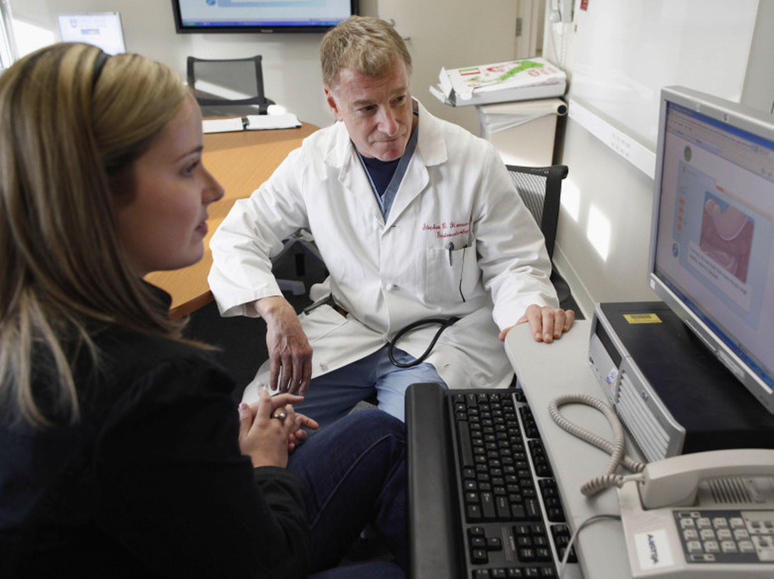 Kristen Miller talks over the risks and benefits of colonoscopy with Stephen Hanauer, chief of gastroenterology at the University of Chicago Medical Center. 