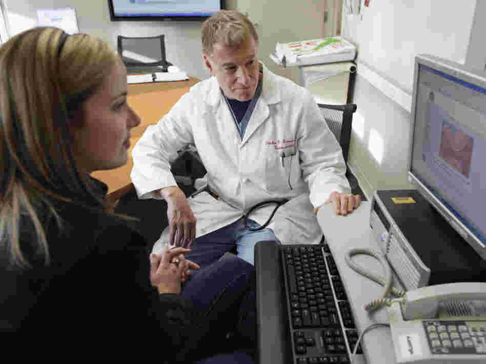 Kristen Miller talks over the risks and benefits of colonoscopy with Stephen Hanauer, chief of gastroenterology at the University of Chicago Medical Center. 