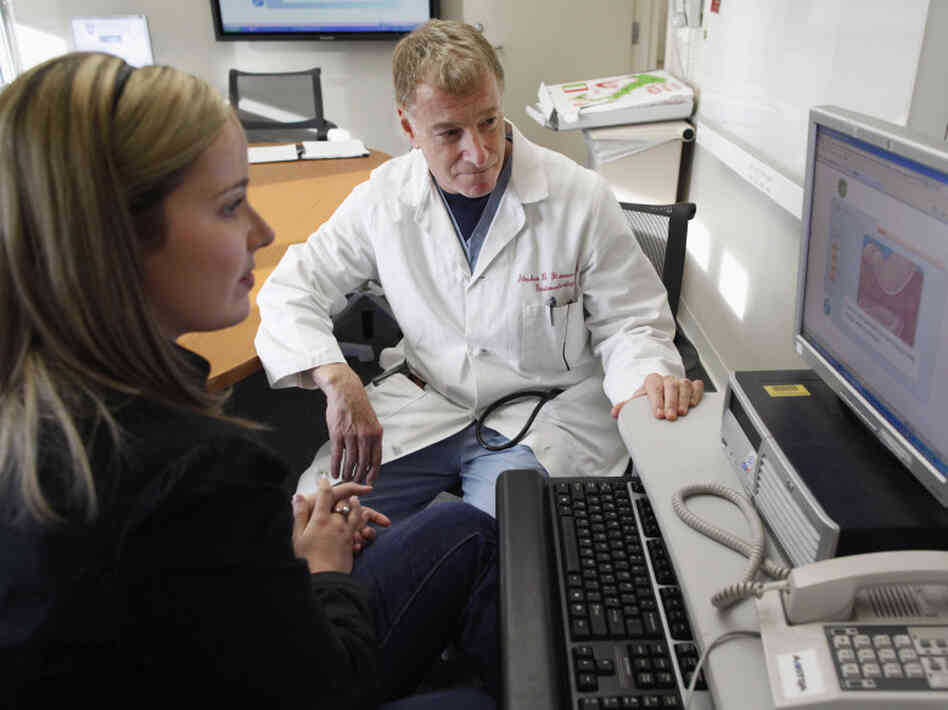 Kristen Miller talks over the risks and benefits of colonoscopy with Stephen Hanauer, chief of gastroenterology at the University of Chicago Medical Center. 