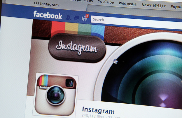 A photo illustration shows the photo-sharing app Instagram's  fan page on Facebook's website. Facebook is acquiring Instagram for some $1 billion.