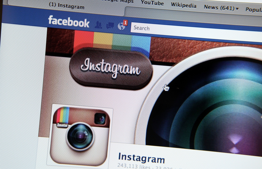 A photo illustration shows the photo-sharing app Instagram's  fan page on Facebook's website. Facebook is acquiring Instagram for some $1 billion.