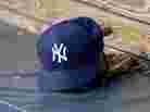 A New York Yankees hat and glove rest in the dugout before a game at Oriole Park at Camden Yards. A New York Yankees hat and glove rest in the dugout before a game at Oriole Park at Camden Yards.