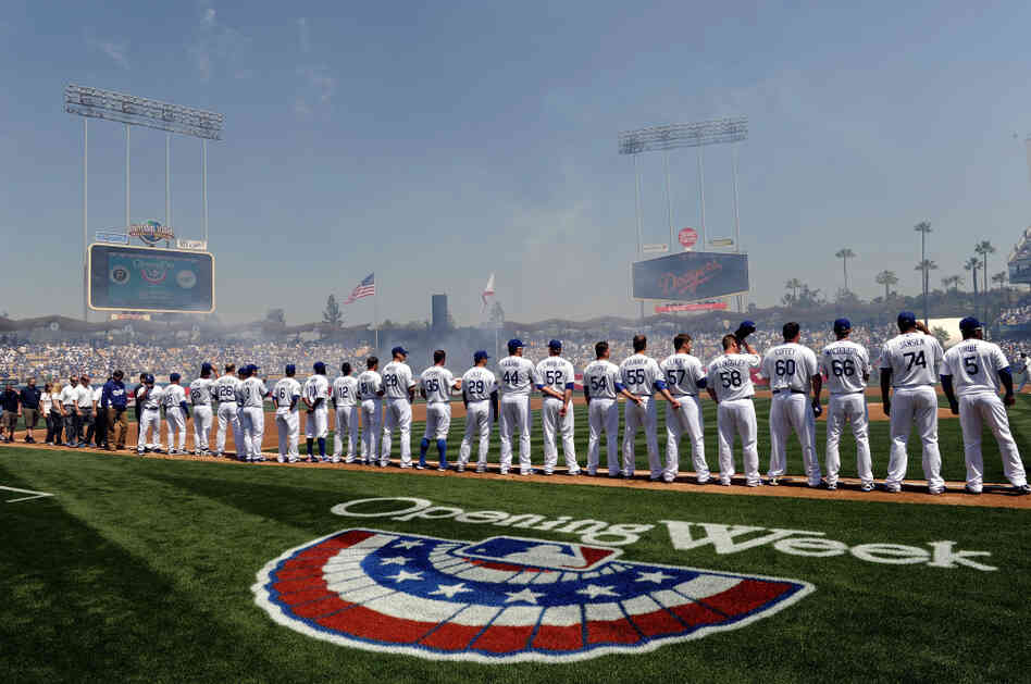 The L.A. Dodgers stand on the third baseline during the national anthem on opening day at Dodger Stadium. They beat the Pittsburgh Pirates, 2-1, on Tuesday in Los Angeles. The L.A. Dodgers stand on the third baseline during the national anthem on opening day at Dodger Stadium. They beat the Pittsburgh Pirates, 2-1, on Tuesday in Los Angeles.