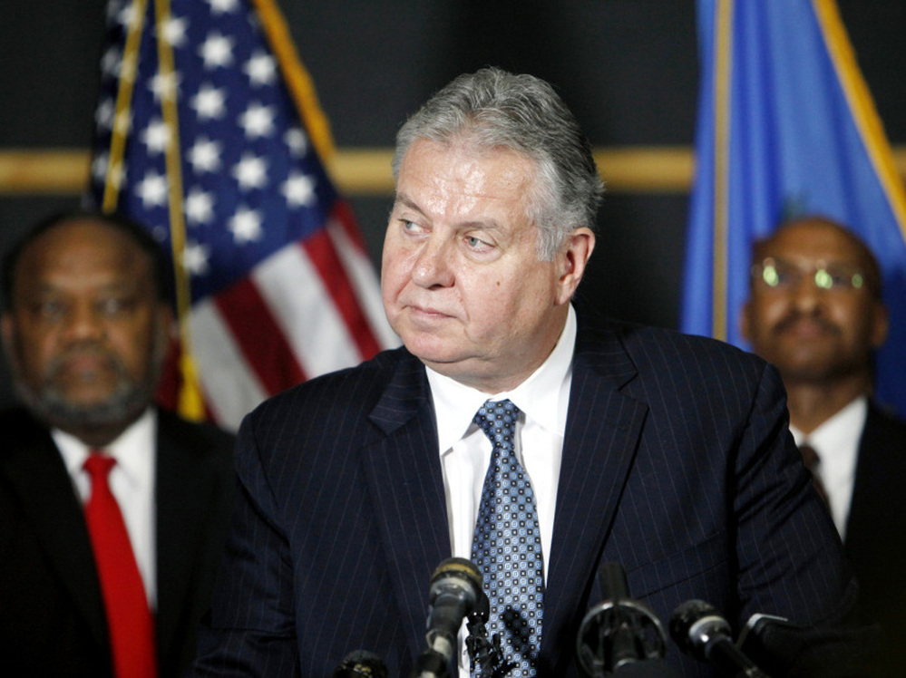 Tulsa Police Chief Chuck Jordan (center) speaks as City Councilor Jack Henderson (right) and FBI agent James Finchother listen during a news conference on Sunday in Tulsa, Okla. 
