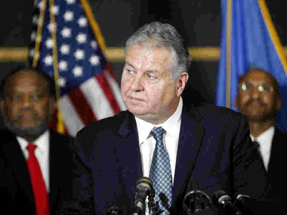 Tulsa Police Chief Chuck Jordan (center) speaks as City Councilor Jack Henderson (right) and FBI agent James Finchother listen during a news conference on Sunday in Tulsa, Okla. 