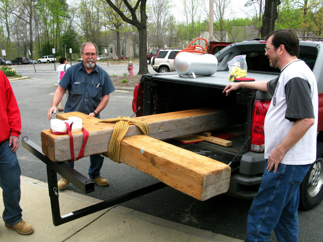 Wayne Marsh (right) and Loren Nystrom (left) help put the Church of the Apostles' cross into storage. The church will be shuttered and, eventually, sold by the Episcopal Diocese. 