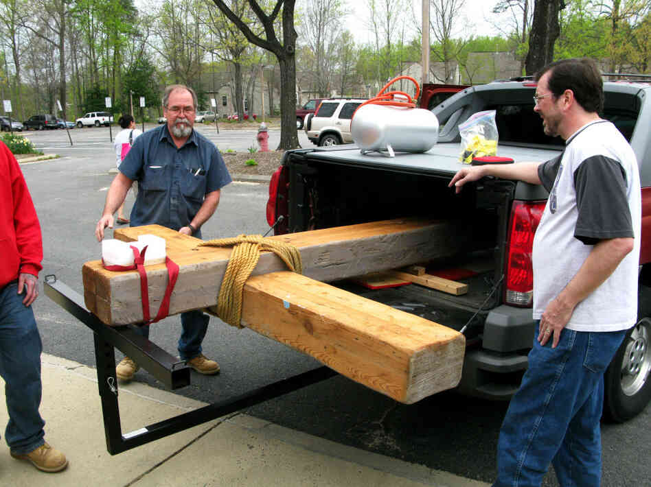 Wayne Marsh (right) and Loren Nystrom (left) help put the Church of the Apostles' cross into storage. The church will be shuttered and, eventually, sold by the Episcopal Diocese. 