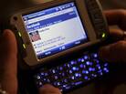 A woman uses her smartphone to access Facebook. Several states are close to banning employers from asking job applicants for their social media login information. A woman uses her smartphone to access Facebook. Several states are close to banning employers from asking job applicants for their social media login information.