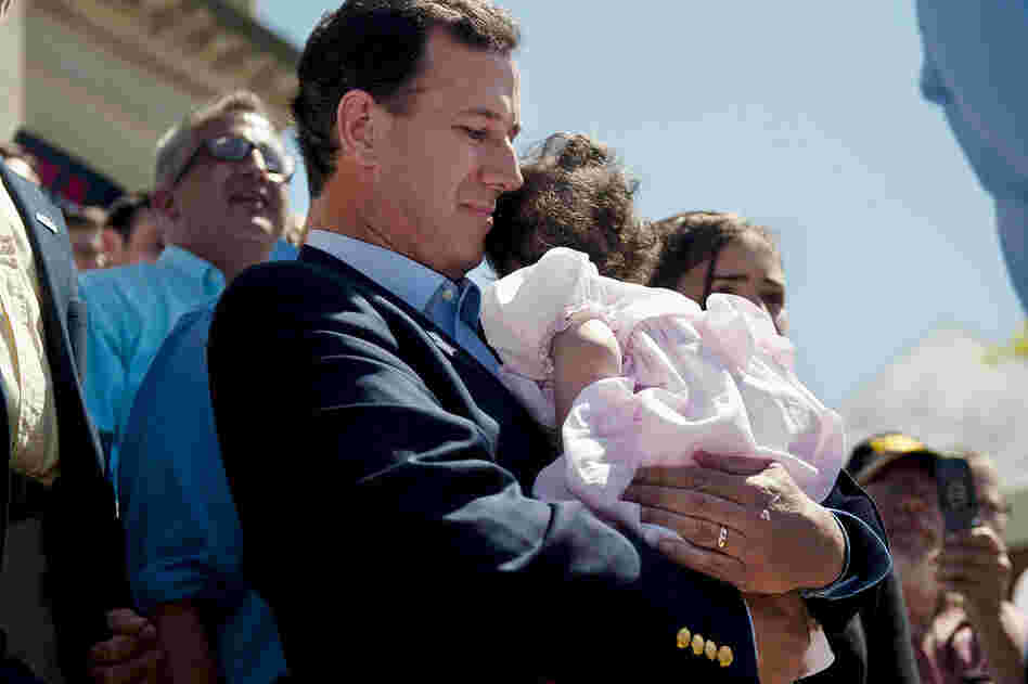 Santorum, shown holding his youngest child, Bella, who has a rare genetic disease, left the trail twice when she was hospitalized. 