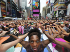 Bernice Acosta and other yoga enthusiasts practice in New York's Times Square at an event marking the 2011 summer solstice. Some Hindus say such events have little to do with yoga's spiritual roots. Bernice Acosta and other yoga enthusiasts practice in New York's Times Square at an event marking the 2011 summer solstice. Some Hindus say such events have little to do with yoga's spiritual roots.