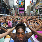Bernice Acosta and other yoga enthusiasts practice in New York's Times Square at an event marking the 2011 summer solstice. Some Hindus say such events have little to do with yoga's spiritual roots. 