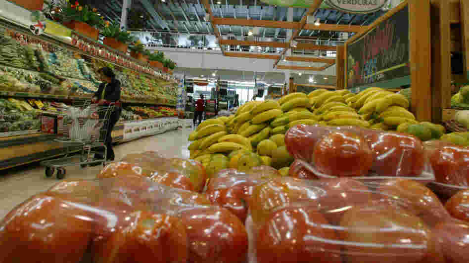  A woman looks over vegetables in Carulla Supermarket in Bogota, Colombia. The country, which plays host this weekend to the Summit of the Americas, is a rising star in the region. Foreign investment has quadrupled over the past decade, and it has a new free-trade agreement with the U.S.