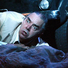 In a production of Verdi's opera Rigoletto at the Sydney Opera House, the title character (baritone Jonathan Summers) reels at the discovery of his dead daughter.