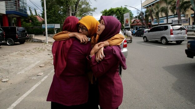 Acehnese women hug each other shortly after the powerful  earthquake hit the western coast of Sumatra in Banda Aceh.