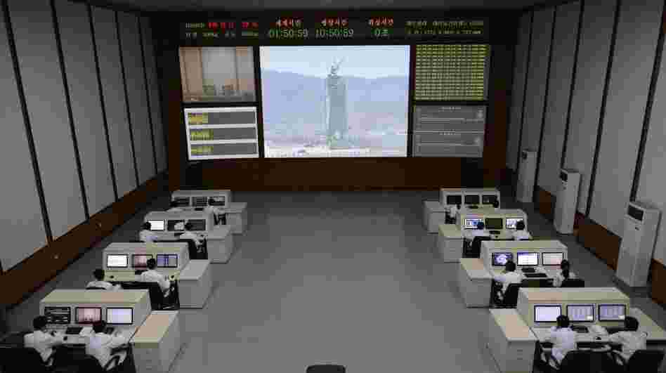 North Korea technicians watch live images of the rocket fueling at the satellite control room of the space center near Pyongyang.