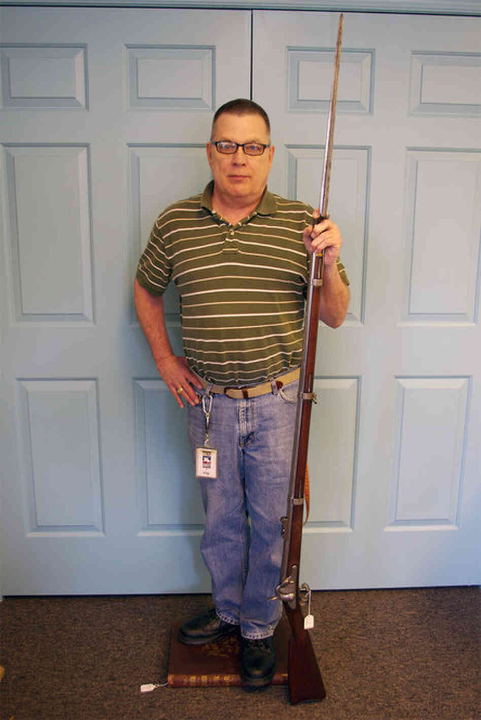 To determine the height of the unidentified Civil War soldier, an employee of The Horse Soldier store in Gettysburg, Pa., recreated the pose in the photo. He stood on a book to bring his height to an even 5 feet 8 inches. 
