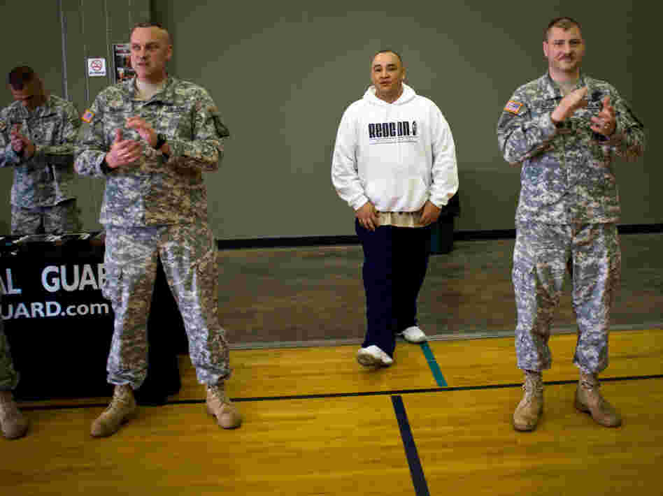 Barillaro (center), of Vallejo, Calif., is introduced to a roomful of new recruits at the National Guard Armory in Evansville, Ind. First Sgt. Larry Lightburne (right), who organized a performance by Barillaro at the armory, heard about the rapper through his wife, who found his lyrics comforting while he was stationed in Iraq.