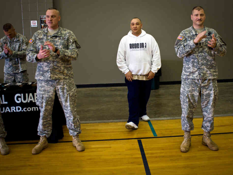 Barillaro (center), of Vallejo, Calif., is introduced to a roomful of new recruits at the National Guard Armory in Evansville, Ind. First Sgt. Larry Lightburne (right), who organized a performance by Barillaro at the armory, heard about the rapper through his wife, who found his lyrics comforting while he was stationed in Iraq.