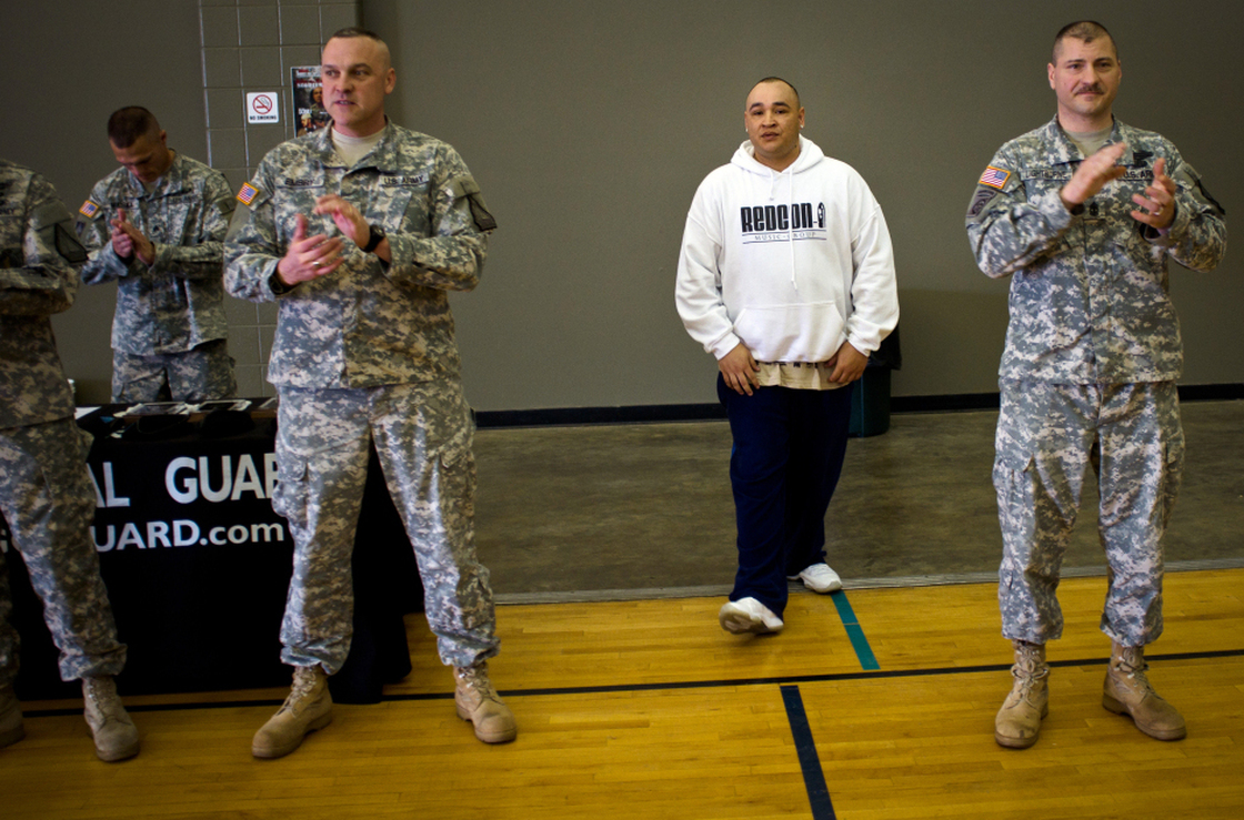 Barillaro (center), of Vallejo, Calif., is introduced to a roomful of new recruits at the National Guard Armory in Evansville, Ind. First Sgt. Larry Lightburne (right), who organized a performance by Barillaro at the armory, heard about the rapper through his wife, who found his lyrics comforting while he was stationed in Iraq.