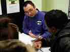 In this Friday, Jan. 6, 2012 photo, Tai Sung, a master tax advisor for H&R Block, center, consults with clients about their taxes at his office in Rockville, Md. In our second hour, listeners talk about the lessons they've learned over years of filing.