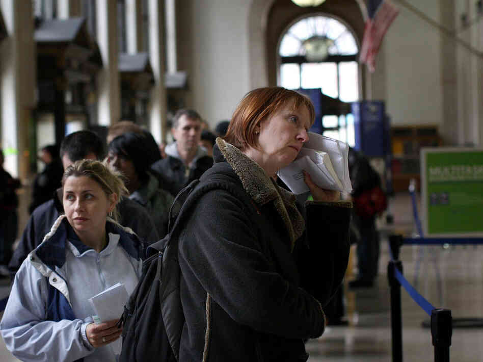 People wait in line inside the Farley Post Office building on Tax Day 2009 in New York City. 