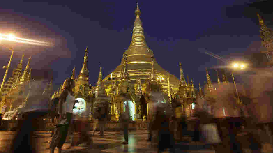 A foreigner pauses to look at the glittering Shwedagon Pagoda, a famous landmark in Myanmar, in Yangon in February. The country's tourism industry is racing to keep up with the rush of visitors now that Myanmar is opening to the outside world. A foreigner pauses to look at the glittering Shwedagon Pagoda, a famous landmark in Myanmar, in Yangon in February. The country's tourism industry is racing to keep up with the rush of visitors now that Myanmar is opening to the outside world.