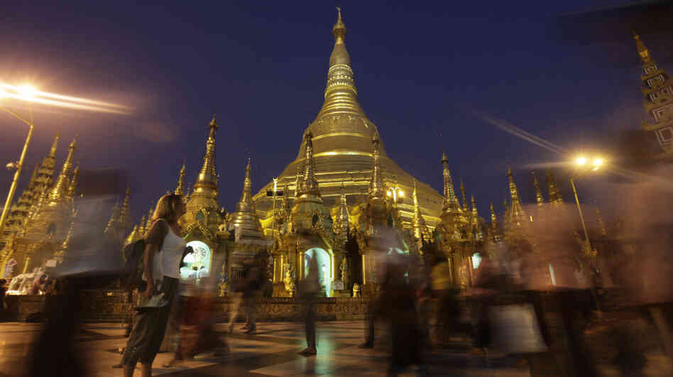 A foreigner pauses to look at the glittering Shwedagon Pagoda, a famous landmark in Myanmar, in Yangon in February. The country's tourism industry is racing to keep up with the rush of visitors now that Myanmar is opening to the outside world. A foreigner pauses to look at the glittering Shwedagon Pagoda, a famous landmark in Myanmar, in Yangon in February. The country's tourism industry is racing to keep up with the rush of visitors now that Myanmar is opening to the outside world.