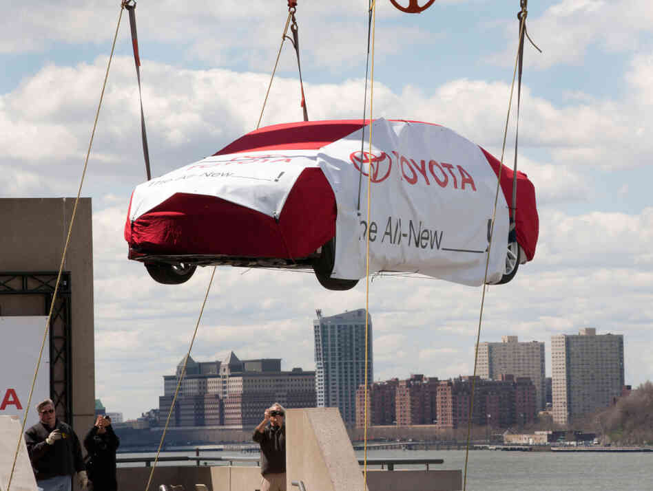 A crane lifts a Toyota to the top level of New York's Javits Convention Center on April 2, before the New York International Auto Show. A crane lifts a Toyota to the top level of New York's Javits Convention Center on April 2, before the New York International Auto Show.