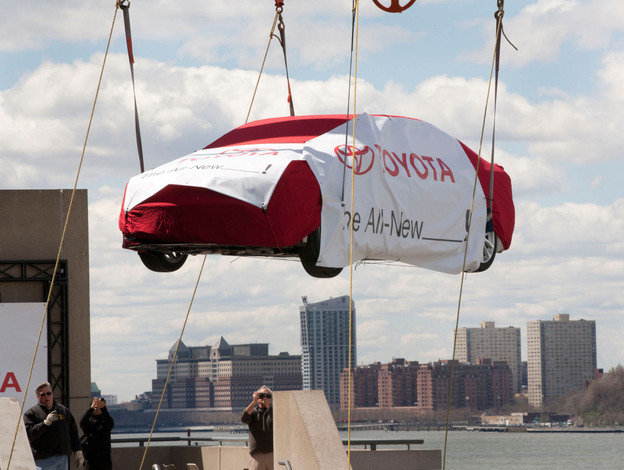 A crane lifts a Toyota to the top level of New York's Javits Convention Center on April 2, before the New York International Auto Show. A crane lifts a Toyota to the top level of New York's Javits Convention Center on April 2, before the New York International Auto Show.