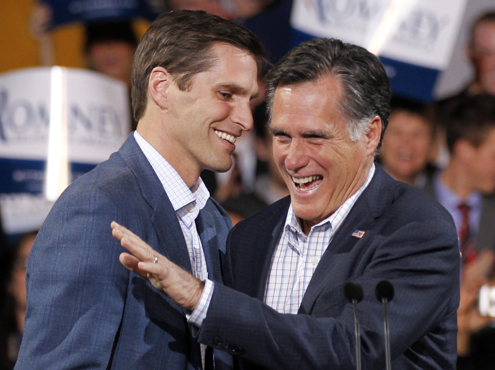 Republican presidential candidate Mitt Romney, seen at an election night rally in Denver with his son Josh on Feb. 7, once rode to the rescue on a Jet Ski. 