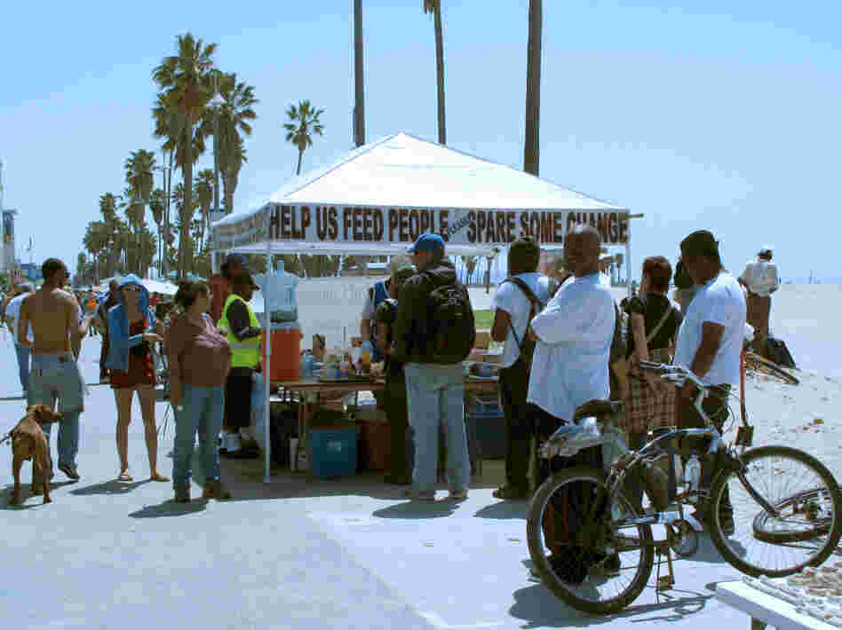 A food tent on Venice Beach, west of Los Angeles, offers a meal to homeless people and others in need. A new project in the area has the goal of reducing the area's homeless military veterans.