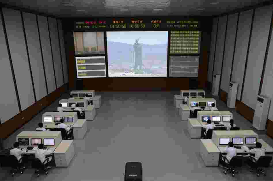 North Korean technicians watch live images of the rocket Unah-3 at the satellite control room of the space center on the outskirts of Pyongyang on Wednesday.