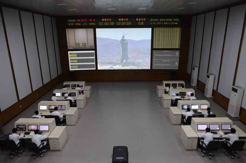 North Korean technicians watch live images of the rocket Unah-3 at the satellite control room of the space center on the outskirts of Pyongyang on Wednesday.