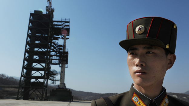 Prior to today's launch, a North Korean soldier stood guard. (AFP/Getty Images)