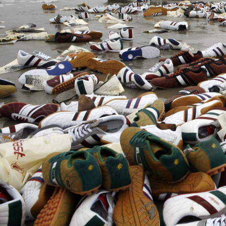Tennis shoes lay on the beach on Terschelling island, Netherlands, Feb. 10, 2006. They were from a shipping container that fell off a ship during a storm.
