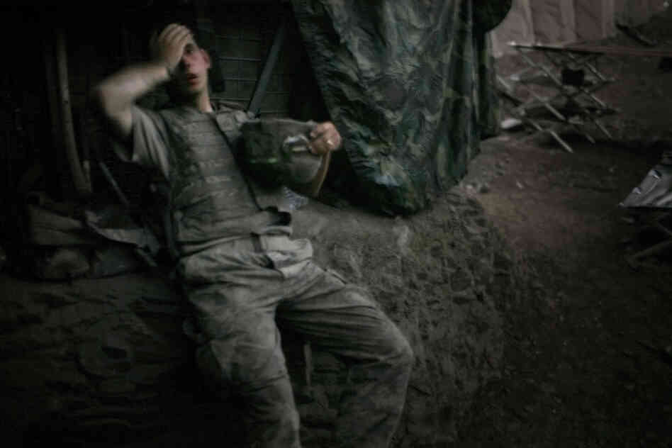 July 2007: A soldier from 2nd Platoon rests at the end of a day of heavy fighting at the Restrepo outpost.