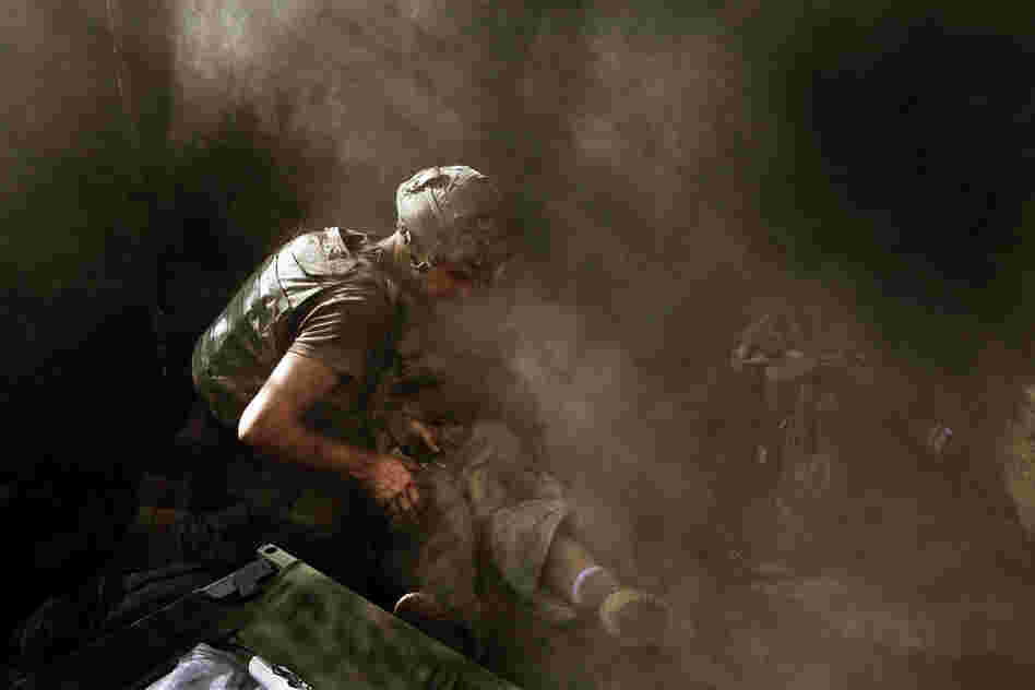 2007: Medic David "Doc" Old treats Spc. Miguel Gutierrez of the 2nd Platoon, who was injured during an attack by Taliban fighters on the Restrepo outpost in Afghanistan's Korengal Valley.