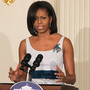 First lady Michelle Obama says raising her two daughters in the White House "has been less stressful than I would have imagined." Seen here at the White House in March, the first lady's new project aims to help military veterans and their families.